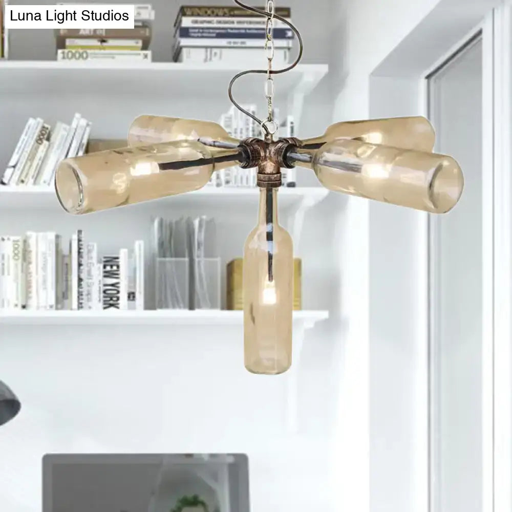 A rustic amber glass bottle chandelier with aged silver black brass frame and smoke gray blue hanging chain lighting fixture