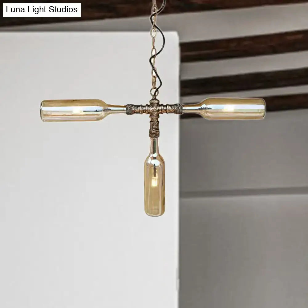A rustic farmhouse style chandelier with three amber glass bottles hanging from an aged silver black twisted chain