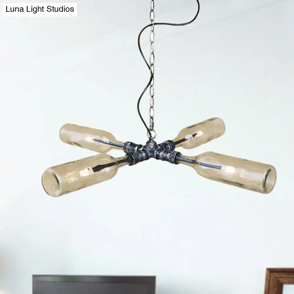Industrial-style chandelier with four amber glass bottles on a dark metal aged silver black hub and chain in smoke gray blue finish