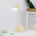 Cream-colored flexible-neck led desk lamp with rounded base and soft-glowing shade in white pink blue for reading