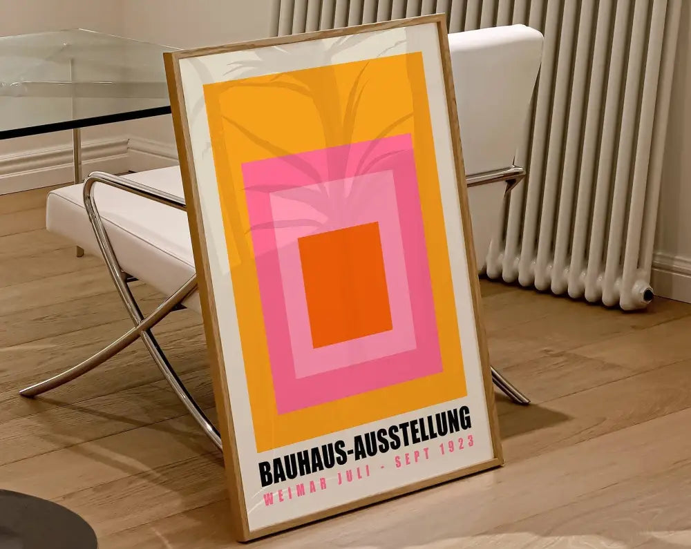 A framed decorbites™ geometric bauhaus canvas print featuring concentric orange pink and yellow squares for modern decor