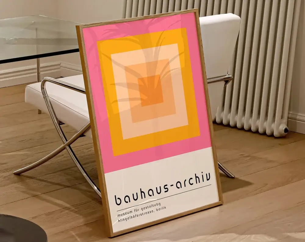 A framed decorbites geometric bauhaus canvas print featuring concentric pink yellow and orange squares modern wall art