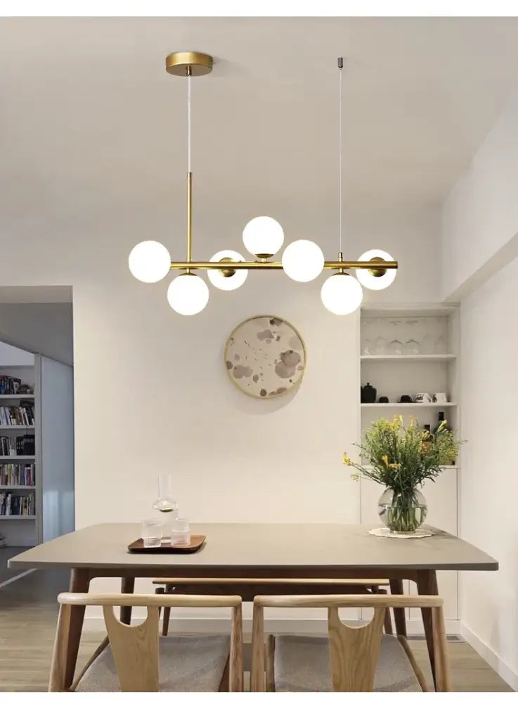 Modern gold-toned glass ball chandelier with multiple spherical bulbs designed for living rooms by DecorBites™