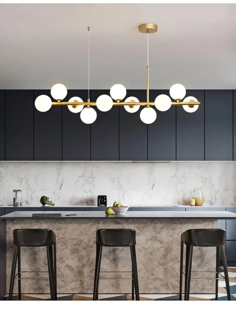 Modern gold-toned DecorBites™ glass ball chandelier with multiple white glass ball bulbs in a linear ball ceiling design