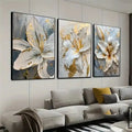 Decorbites gold and white floral 3d canvas wall art featuring three-panel white flower canvas with gold accents and textured brushstrokes framed in black