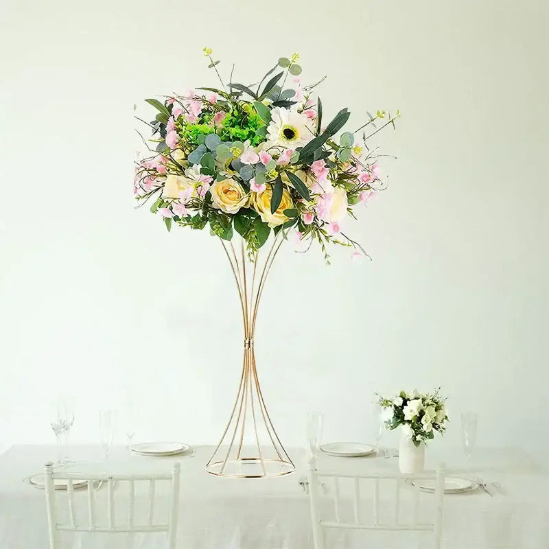 Tall gold iron flower vase set with pink and yellow roses and greenery for wedding decor by decorbites