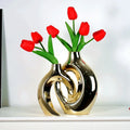 Shiny golden flower vase with sculptural ceramic design holding vibrant red tulips for home decor accessory