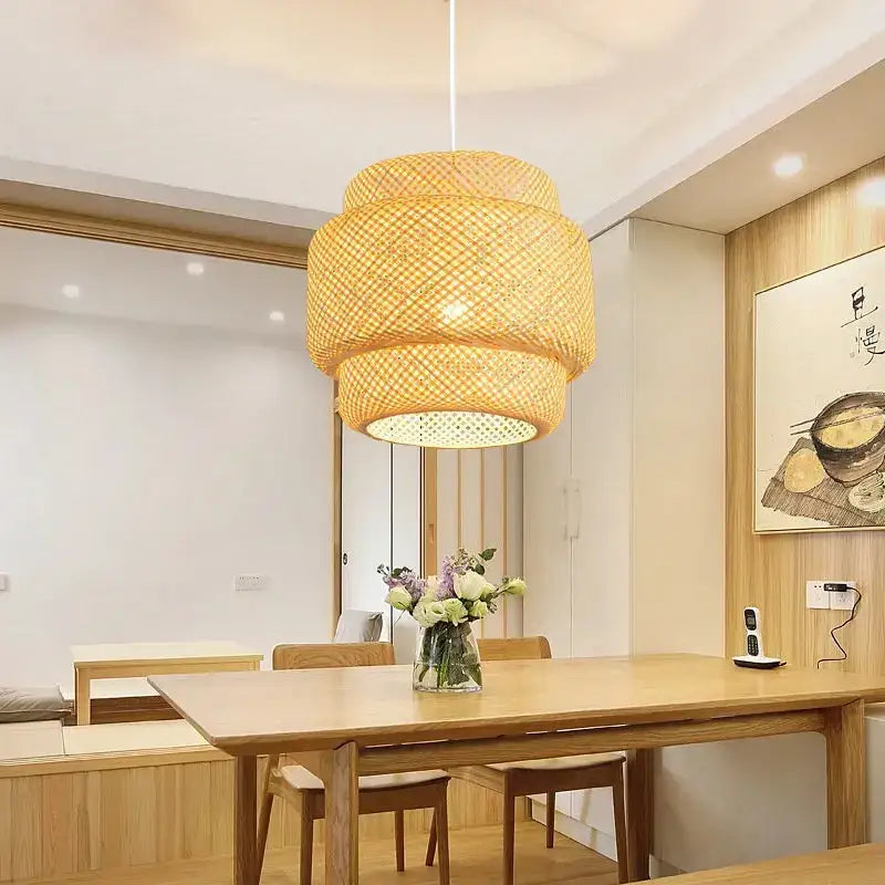 A warm golden hand knitted chinese style tiered pendant light made of woven natural bamboo by decorbites