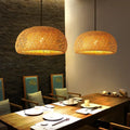 DecorBites™ hand-woven warm-toned bamboo pendant light chandelier with dome-shaped design above dining table