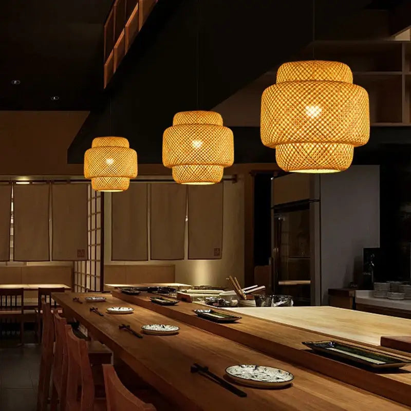 Decorbites™ hand-woven bamboo pendant light chandelier with warm-toned tiered design above wooden dining table