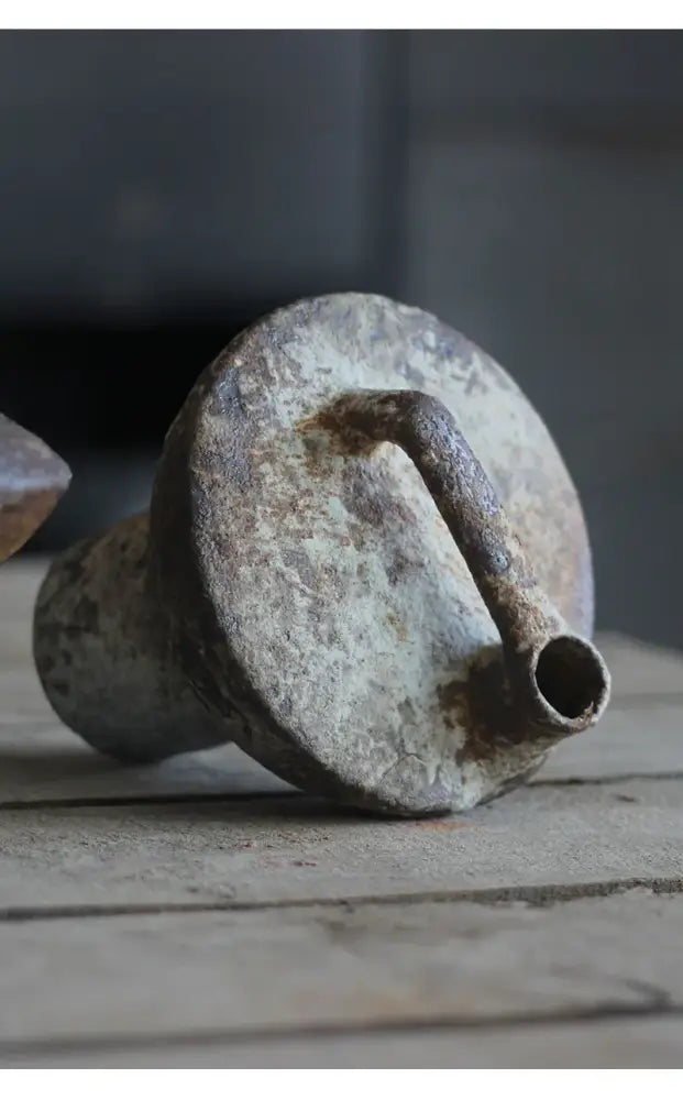 Rusty weathered metal funnel with circular top and narrow spout shown as back side of decorbites™ ceramic vase for dried flowers