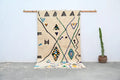 Beige handmade moroccan azilal rug with black green blue and orange geometric patterns 250x141 cm by decorbites
