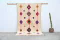 Beige handmade moroccan azilal rug with vibrant pink purple green and orange geometric patterns 250x148 cm decorbites