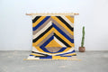 Vibrant handmade moroccan azilal rug with bold yellow blue black and beige stripes in a geometric abstract pattern