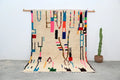 Beige moroccan azilal rug with vibrant pink blue green and black wool geometric patterns handmade 313x194cm decorbites