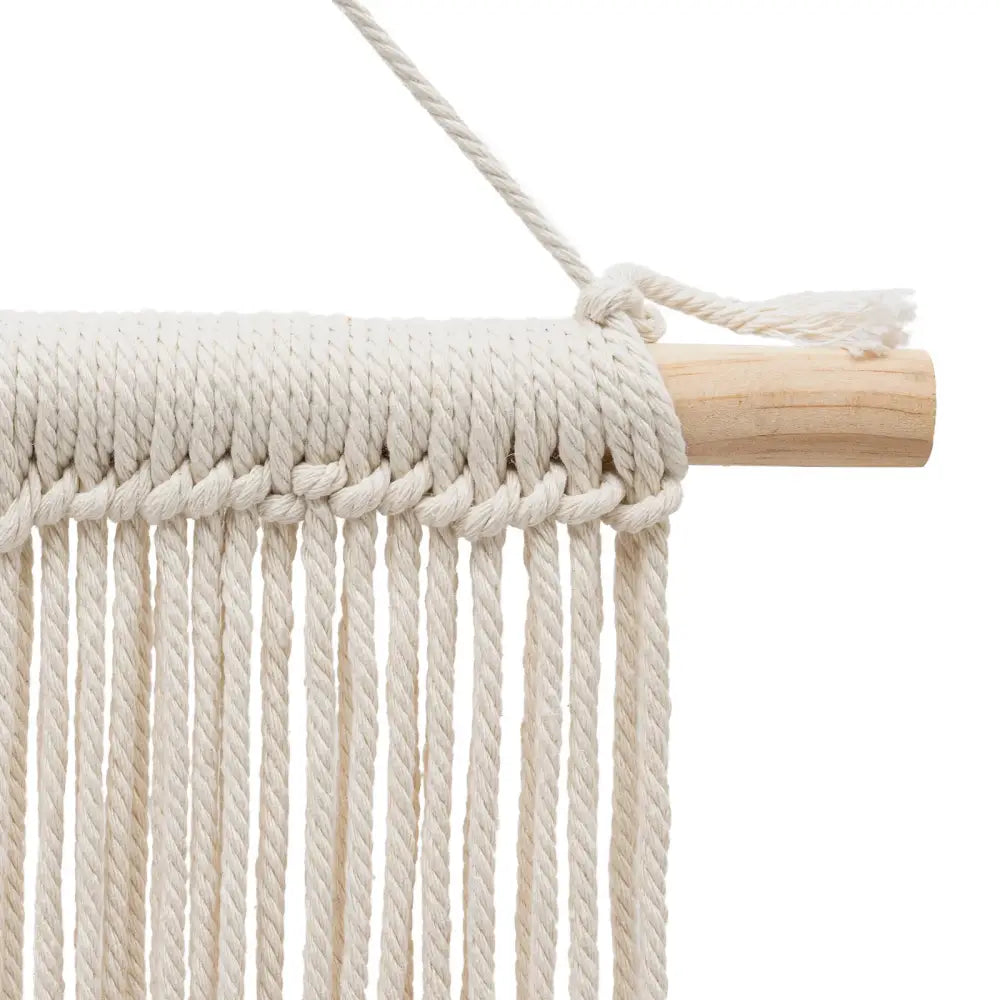 Cream-colored handmade weaving macrame wall hanging with wooden dowel and braided rope for decorative use