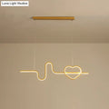 Gold-toned metal led pendant light shaped like an electrocardiogram line ending in a heart for dining room use