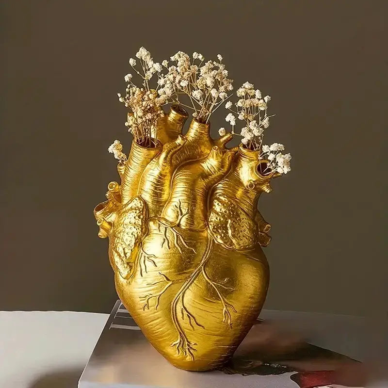 Golden DecorBites™ heart shape resin vase with detailed veins holding dried white baby’s breath flowers