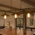 Brass decorbites™ rust scalloped suspended lighting fixture with three exposed filament bulbs and fluted shades