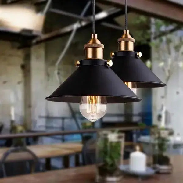 Decorbites™ industrial pendant lighting featuring black metal pendant lights with brass accents and exposed filament bulbs