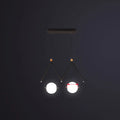Modern black metal suspension light with two glowing ivory glass spheres in minimalist ball restaurant suspension design