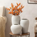 Three white ceramic hydroponic vases with textured ribbed surfaces on a wooden table from decorbites japanese minimalist hydroponic vase set