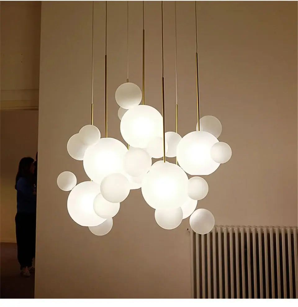 A decorbites™ led bubble chandelier with frosted white spherical bulbs and gold toned rods for nordic decor led lighting