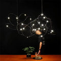 DecorBites™ led firefly chandelier with bright white leds and thin metallic wires showcasing engineering minimal design