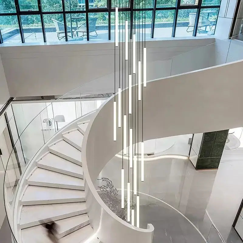 Modern minimalist decorbites™ led spiral staircase chandelier with slender vertical bars suspended by thin cords