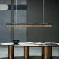 DecorBites™ modern minimalist strip pendant lights feature a sleek black bar with five gold-toned minimalist strip LED fixtures