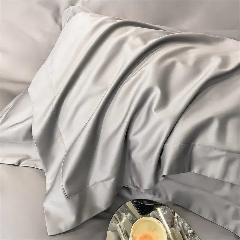 A luxurious silver-gray satin pillowcase from DecorBites™ 1000TC Egyptian cotton bedding set with smooth finish