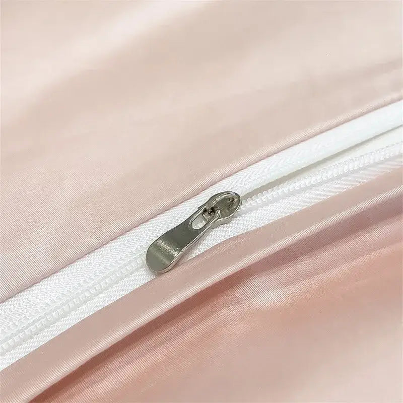 A sleek silver zipper with a metallic pull tab on soft pink satin fabric of decorbites™ 1000tc egyptian cotton duvet cover