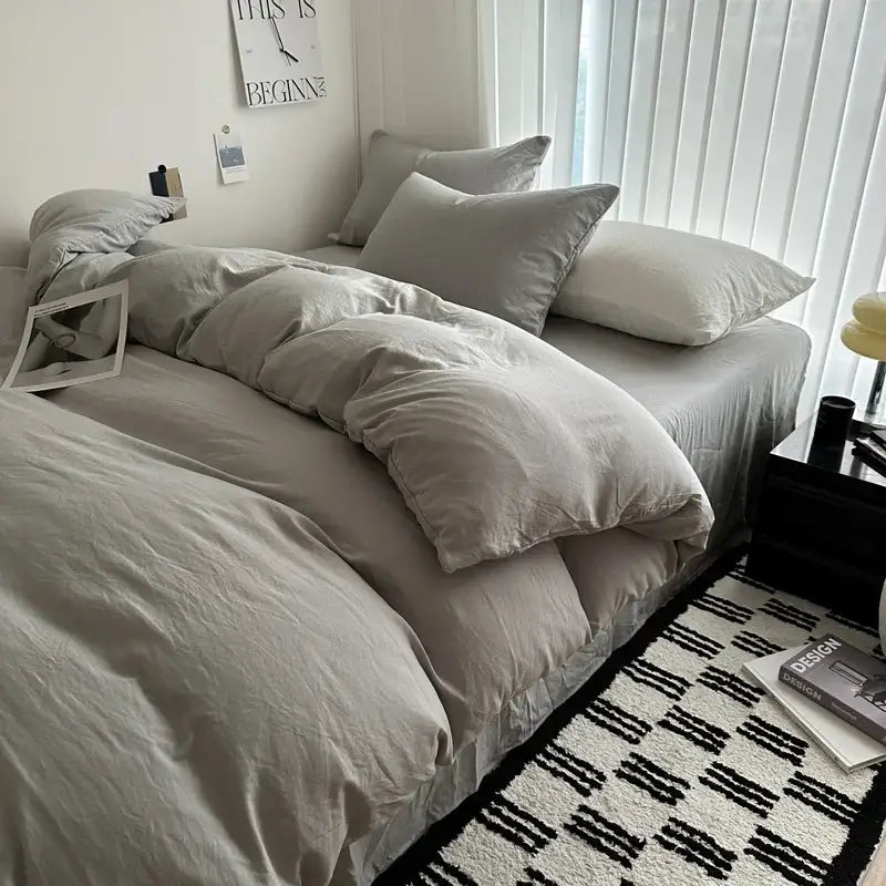 Decorbites™ luxurious cotton bedding set featuring a soft gray duvet cover and matching pillows in neutral tones