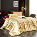 Decorbites™ luxurious silk bedding set featuring a glossy gold satin duvet cover with matching cream and burgundy pillows