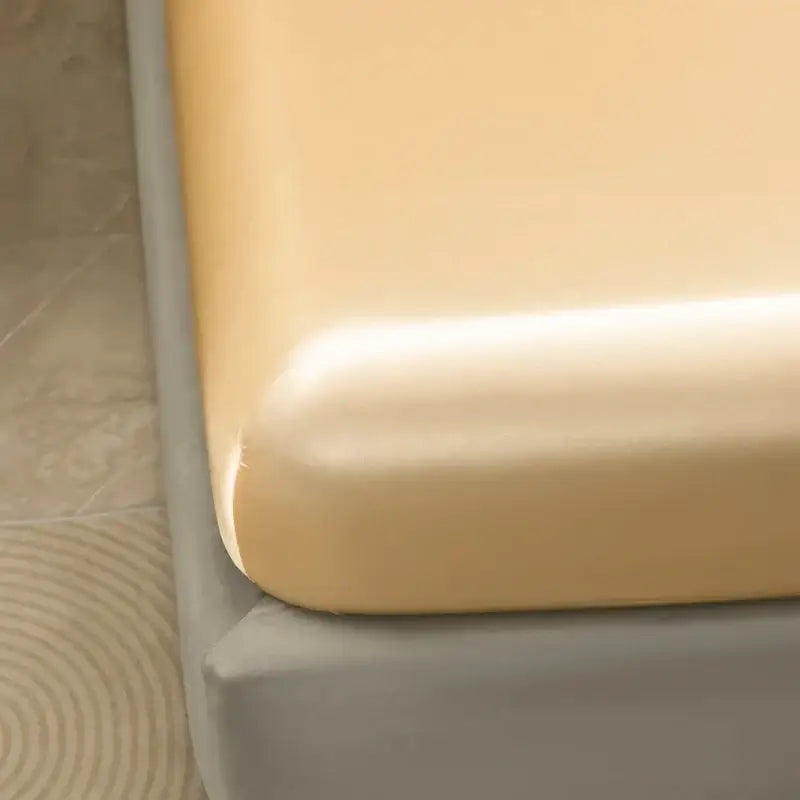 Cream-colored smooth mattress protector with snug fit over bed frame from decorbites luxurious solid color bedding set