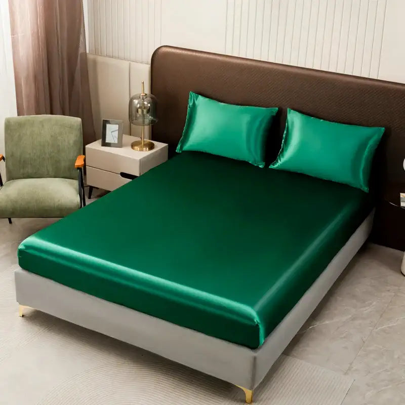 Emerald green satin bedding set by DecorBites™ featuring a solid color flat sheet with smooth, glossy finish and elegant drape