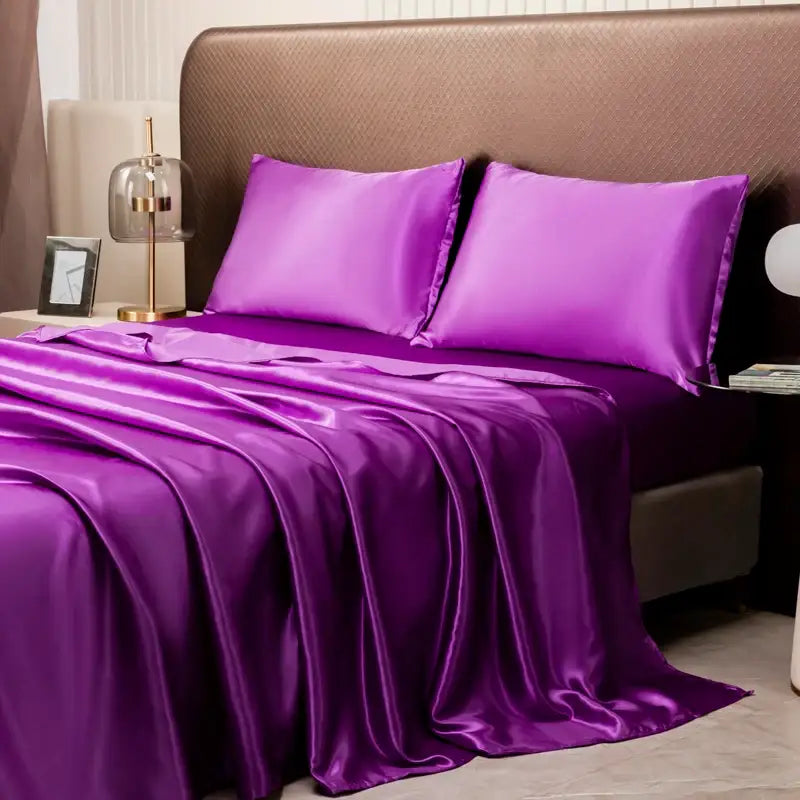 Lustrous purple solid color satin bedding set by DecorBites with a flat sheet and matching pillowcases