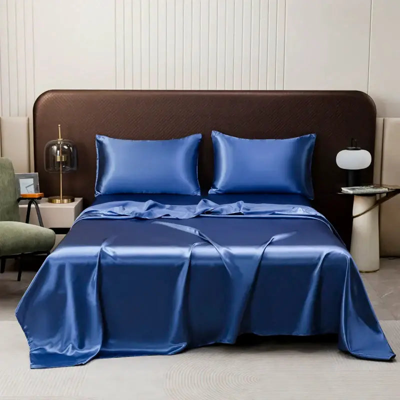 Royal blue solid color satin bedding set by DecorBites with a smooth flat sheet and matching pillowcases