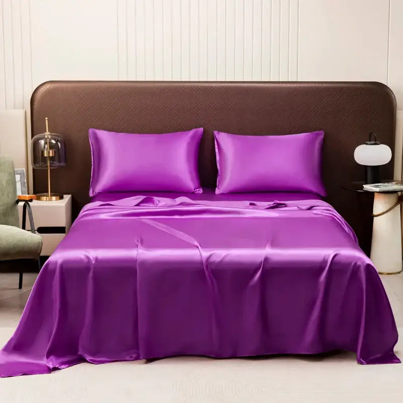 Vibrant purple satin bedding set by DecorBites featuring a solid color flat sheet with a smooth, glossy finish and elegant draping