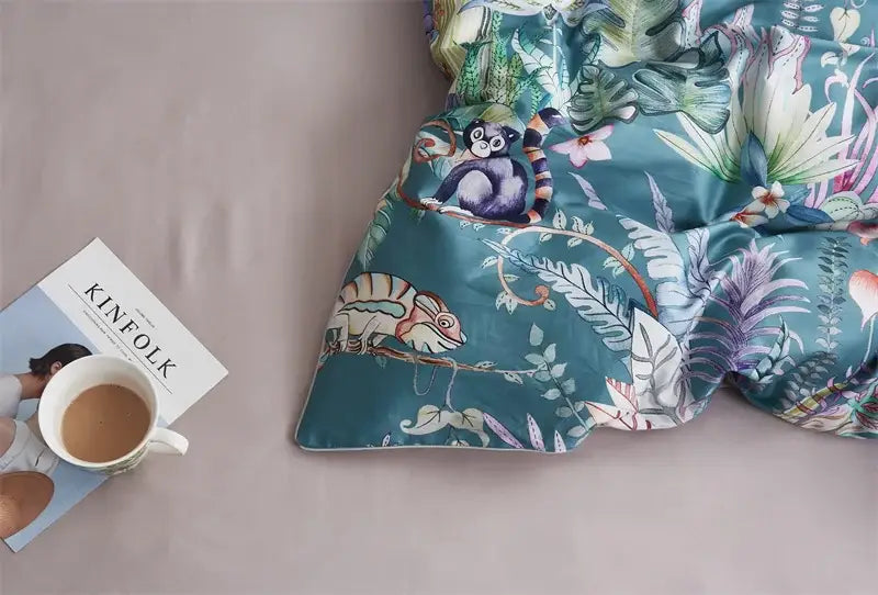 Teal duvet cover and pillowcases featuring a vibrant jungle print made from luxury Egyptian cotton by DecorBites