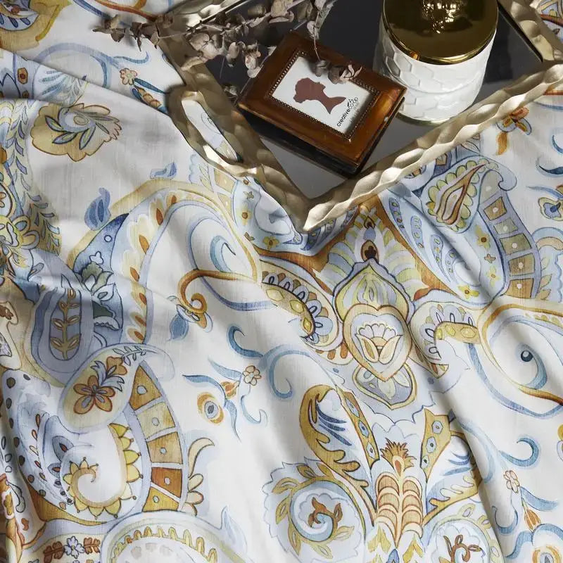 Decorbites™ luxury egyptian cotton duvet cover with intricate gold blue and beige paisley patterns on white fabric