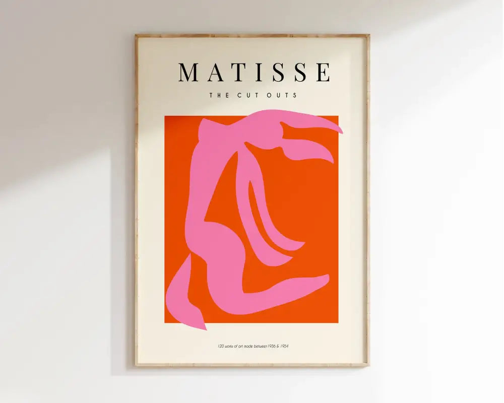 A framed decorbites™ matisse floral art print featuring a bold pink seated figure on orange background with cut outs text