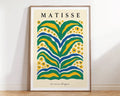 A framed decorbites™ matisse floral art print featuring bold green yellow and blue abstract flowers with matisse text