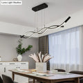 Modern black and white metal LED pendant light fixture with sleek wavy design for dining room island by DecorBites