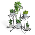 Decorbites metal plant stand is a black wrought iron 6 tier display rack with ornate curved legs holding green plants