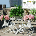 Decorbites™ white metal plant stand with three tiers and floral leaf designs for four potted flowers