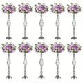 Silver metallic metal vase set with intricate twisted designs holding artificial lavender and white roses by decorbites