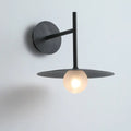 DecorBites™ modern bedside wall light in black matte finish with circular base and frosted glass globe bulb