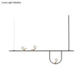 Minimalist black metal light fixture with three white glass sphere shades and cream accents for glass sphere island lighting