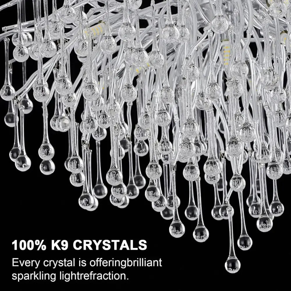 A modern chrome crystal chandelier with cascading clear teardrop k9 crystals in a long raindrop pendant lamp package